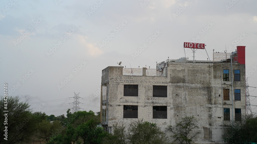 Awesome photo of hotel at Jaipur, India. Green grass field and a hotel shot. Much vegetation has grown around the hotel