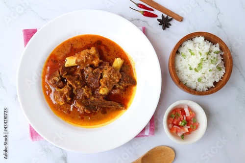 Shahi Mutton curry, Mutton masala, Mutton korma is a famous Spicy non-vegetarian dish of India. It's made out of Goat meat along with spices. Served with rice and roti. copy space.