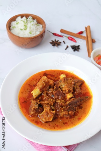 Shahi Mutton curry, Mutton masala, Mutton korma is a famous Spicy non-vegetarian dish of India. It's made out of Goat meat along with spices. Served with rice and roti. copy space.