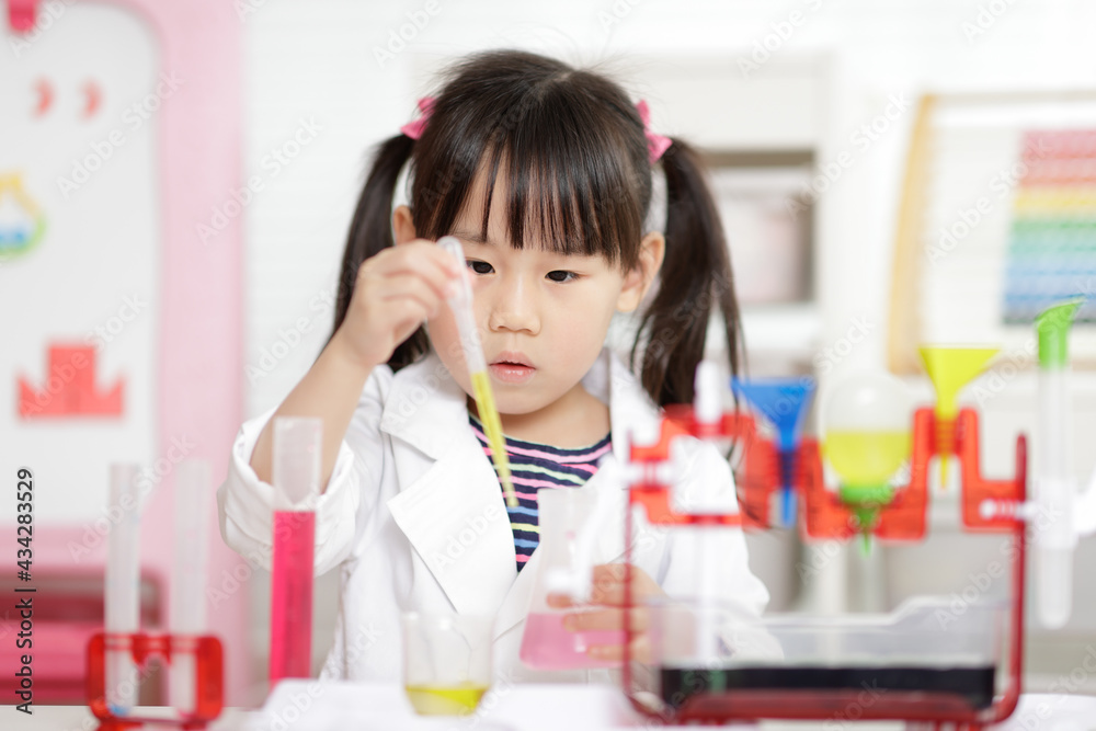 young girl plays colour mixing science experiment for home schooling young girl plays colour mixing science experiment for home schooling