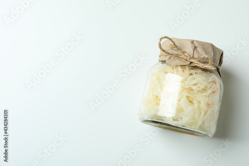 Glass jar of sauerkraut on white background