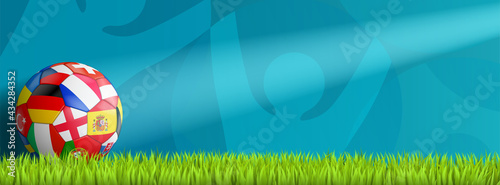 soccer background with colorful ball on abstract turquoise background on green grass