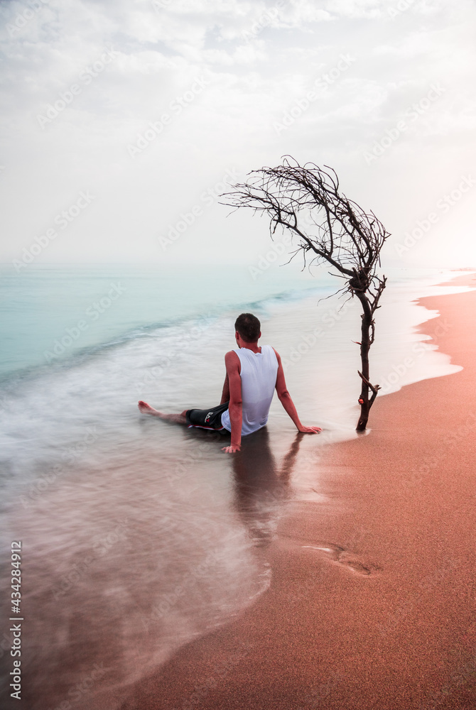Fototapeta premium person meditating on the beach Yoga