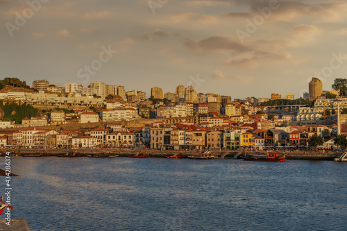 Vila Nova de Gaia skyline with buildings and moored ships by the Douro river in Porto, Portugal