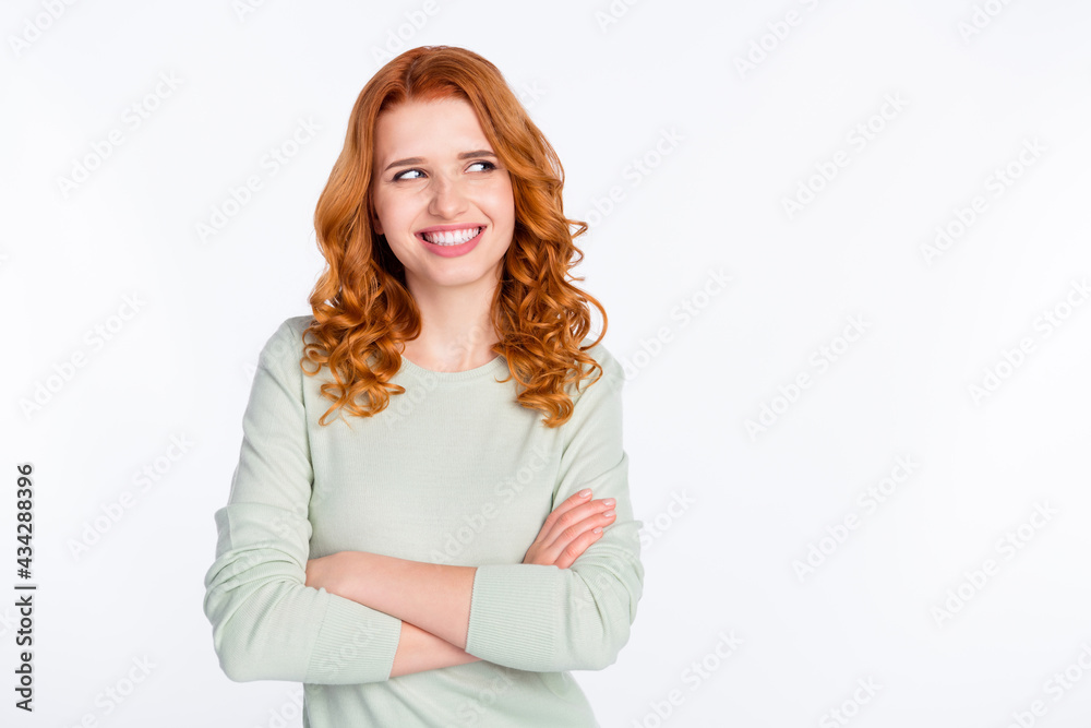 Photo portrait of red haired woman with folded hands smiling looking empty space curious isolated white color background Photo portrait of red haired woman with folded hands smiling looking empty space curious isolated white color background