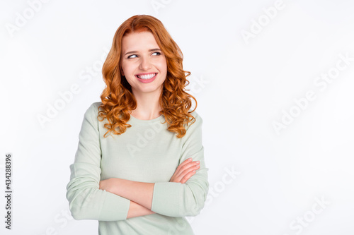 Photo portrait of red haired woman with folded hands smiling looking empty space curious isolated white color background