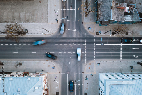 Aerial view of fast blurry cars traffic moving across crossroad in Kaunas city, Lithuania.