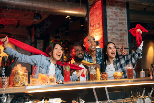 Group of friends watching sport match together. Concept of friendship, leisure activity, emotions