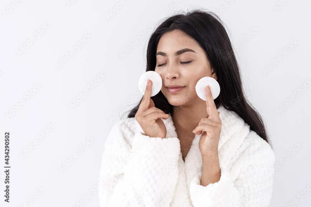 Young asian woman with cotton pads near face Young asian woman with cotton pads near face