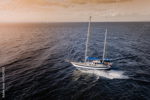 Aerial view of a sailing boat navigating along Vladivostok shore in Amurskiy Zaliv sea, Vladivostok, Russia.