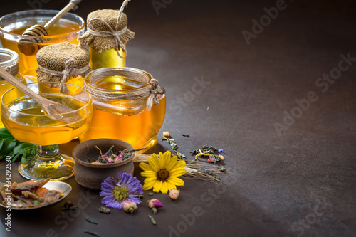Sweet honey with flowers on an old background.