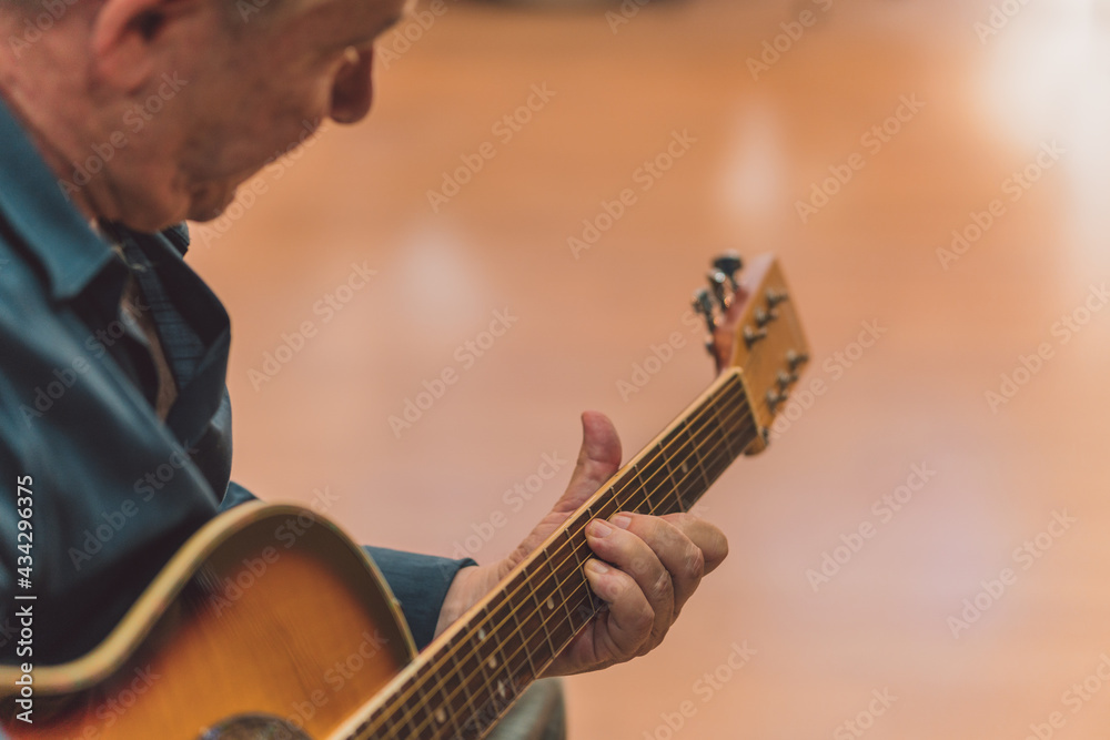 Senior man playing the guitar