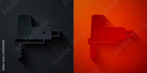 Paper cut Electric jigsaw with steel sharp blade icon isolated on black and red background. Power tool for woodwork. Paper art style. Vector