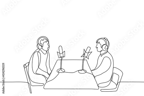 two men are sitting opposite each other wearing over-ear headphones in front of professional microphones - one line drawing. concept of podcast recording, radio interviews, online streaming