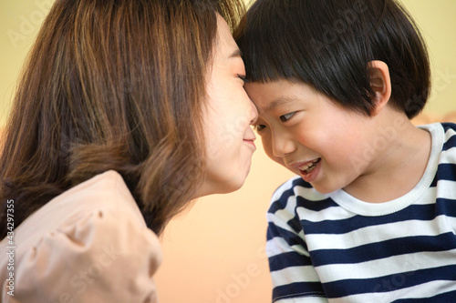 Asian mother is teasing with her son. Quality family time concept. Closed up shot.