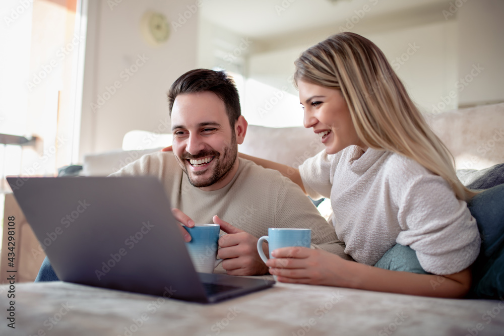 Happy young couple with laptop at home Happy young couple with laptop at home