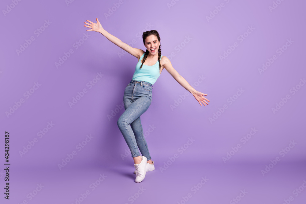 Full length body size view of attractive cheerful friendly girl dancing enjoying having fun isolated over violet purple color background