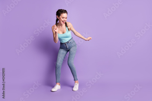 Full length body size photo of dancing woman wearing casual clothes isolated on pastel violet color background with blank space