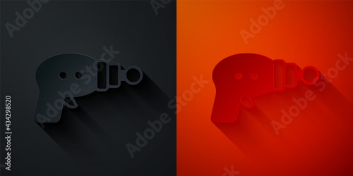 Paper cut Ray gun icon isolated on black and red background. Laser weapon. Space blaster. Paper art style. Vector