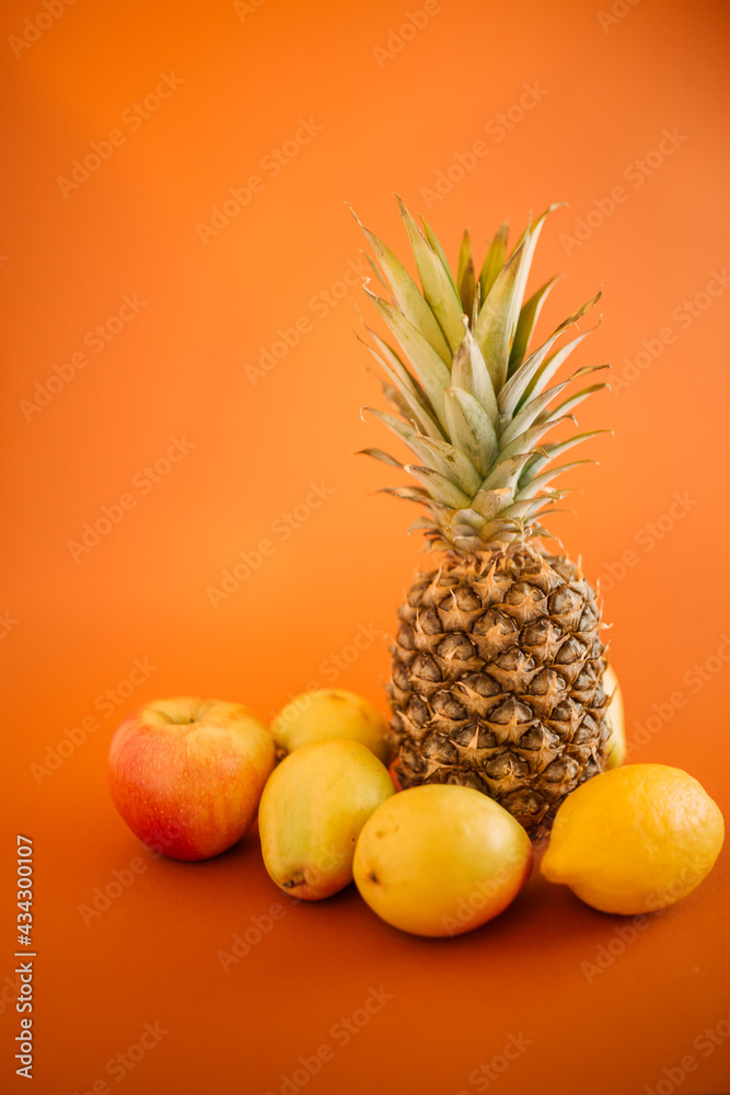 Summer fruits on a pastel background. Pastel colors as a trend. Immunity is achieved with summer fruit. Summer party fun can begin. Pineapple, pears, apples and lemons as a symbol of health. Summer fruits on a pastel background. Pastel colors as a trend. Immunity is achieved with summer fruit. Summer party fun can begin. Pineapple, pears, apples and lemons as a symbol of health.