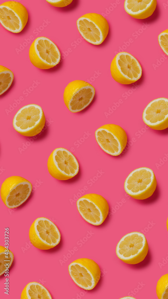 Summer food pattern made with fresh lemons on vibrant pink background. Creative fruit and vegetable texture concept. Healthy vegetarian diet composition. Summer food pattern made with fresh lemons on vibrant pink background. Creative fruit and vegetable texture concept. Healthy vegetarian diet composition.