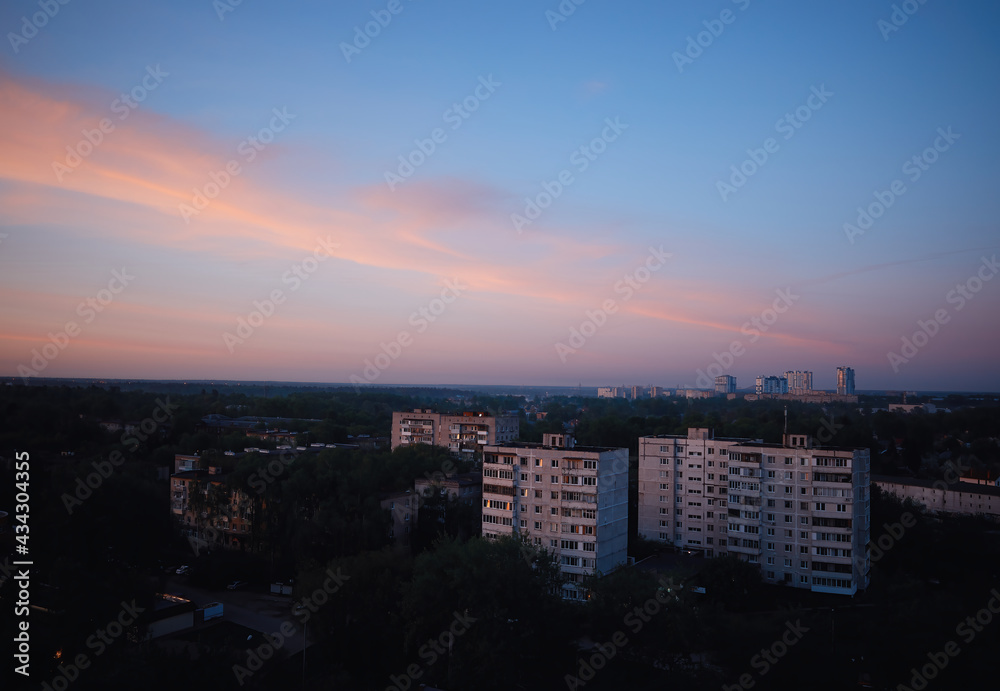 Sunset time at Korolev city background
