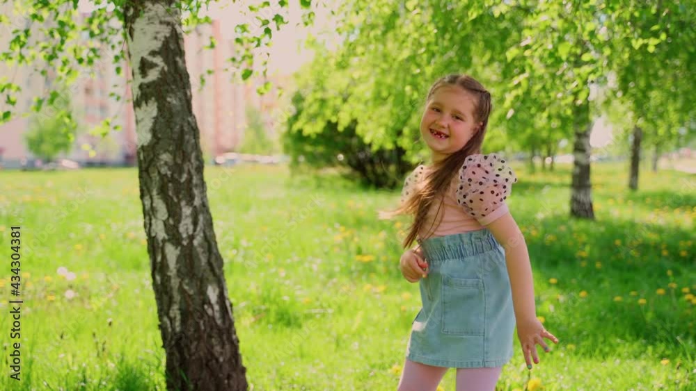 Dancing young child outdoors smile sunlight looking at camera. Happy laughing girl dancer school age female on street shows happiness alone. Portrait little cheerful carefree kid spending time outside Dancing young child outdoors smile sunlight looking at camera. Happy laughing girl dancer school age female on street shows happiness alone. Portrait little cheerful carefree kid spending time outside