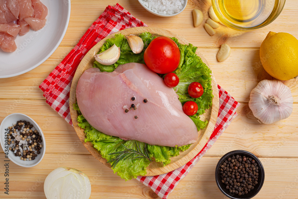 Raw chicken breast on the wooden background. Raw chicken breast on the wooden background.