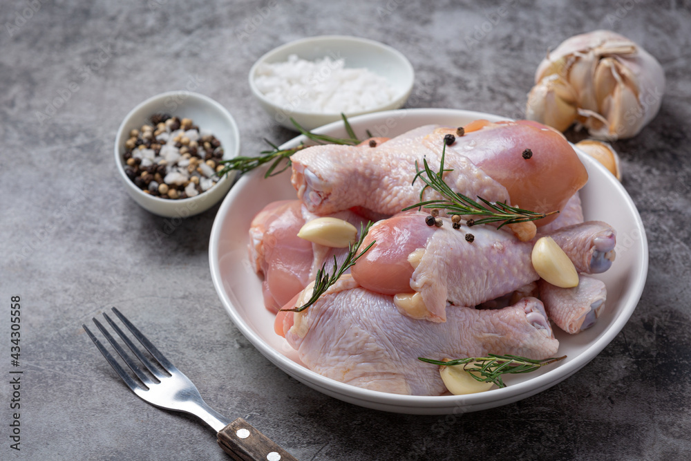 Raw uncooked chicken legs on the dark background. Raw uncooked chicken legs on the dark background.