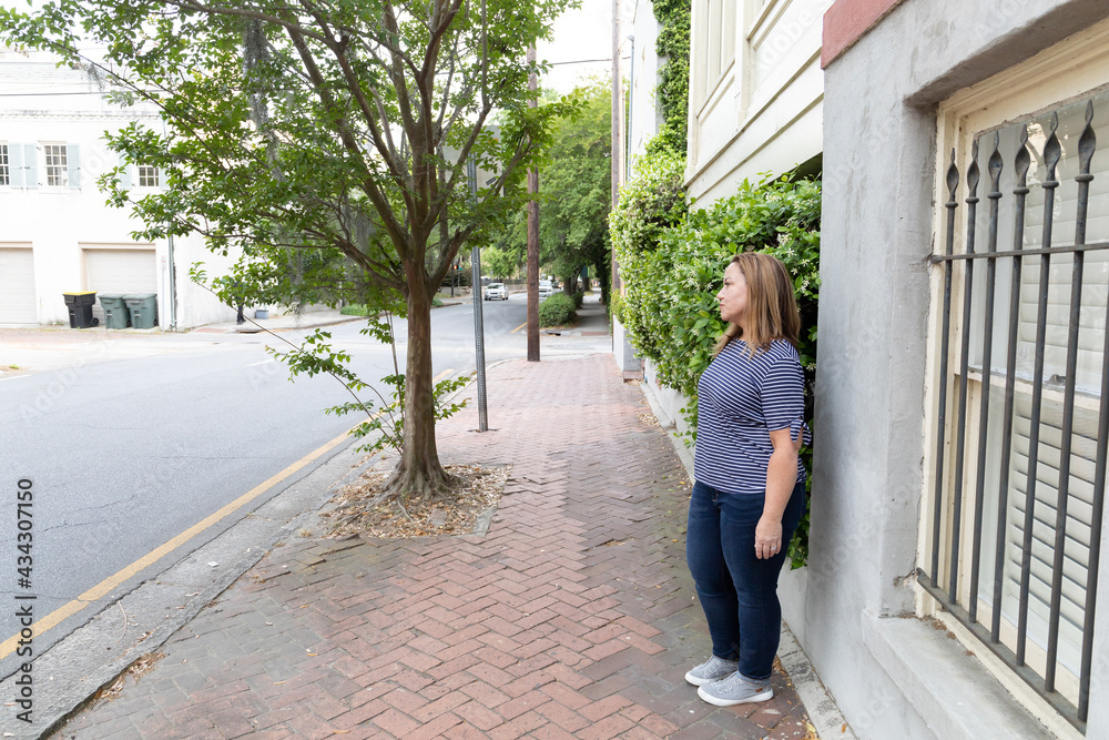 a single woman in her 40's outside in Savannah, Georgia in the spring