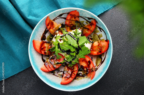 salad with burrata basil and tomatoes top view