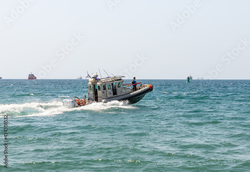 A harbor security speedboat patrols the Mediterranean port of Haifa in Israel