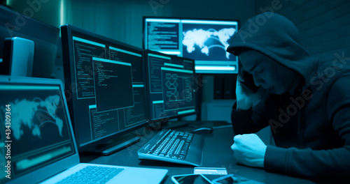 Asian male hacker use computer