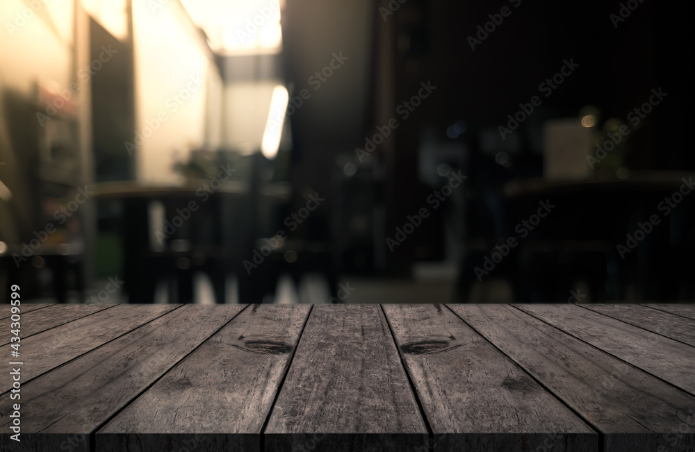 Empty wooden table top with lights bokeh on blur restaurant background Empty wooden table top with lights bokeh on blur restaurant background