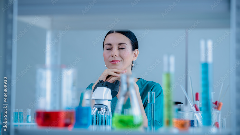Scientist wearing uniform and glass look at camera test tube in laboratory research and development concept for industry or hospital. Scientist wearing uniform and glass look at camera test tube in laboratory research and development concept for industry or hospital.