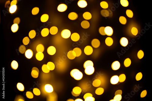 Abstract festive elegant background of blurred with bokeh lights on brown background, defocused