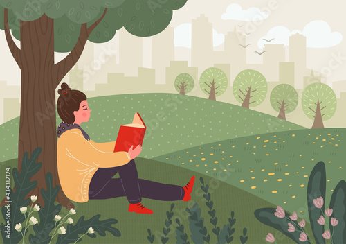 Woman reads book in the city park. Smart girl takes a rest under tree in the park. College student reads, prepares for classes or exams.