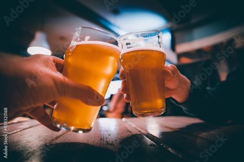 Closeup view of a two glass of beer in hand фототапет