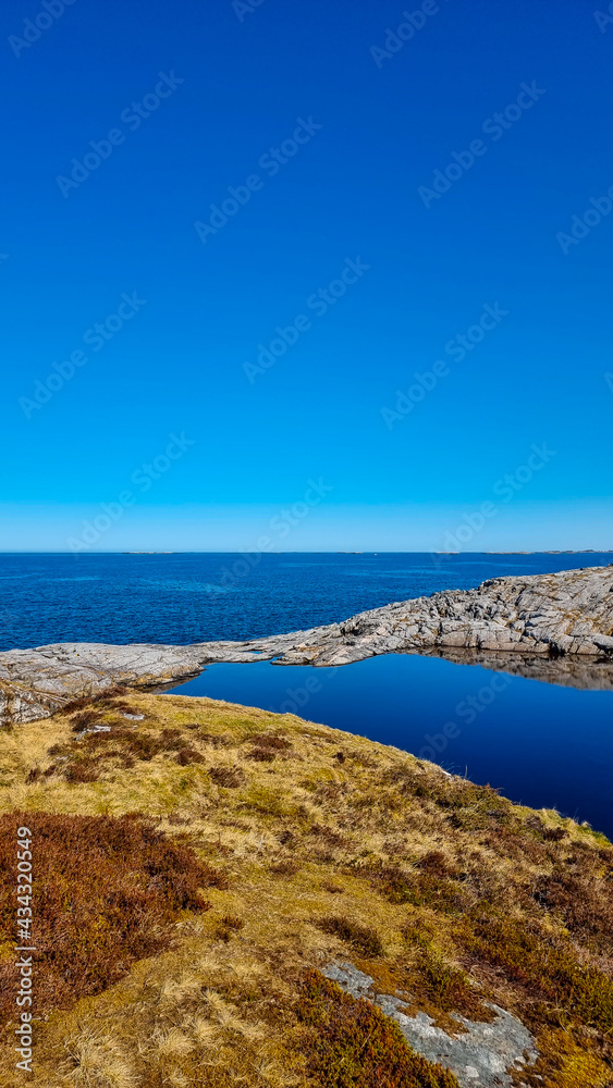 sea and rocks at atlantic ocean with blue sky