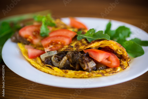 fried egg omelet with wild mushrooms and tomatoes