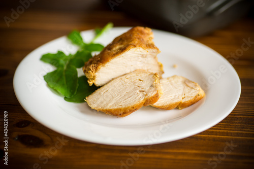 baked chicken fillet pieces with spices and herbs, in a ceramic form