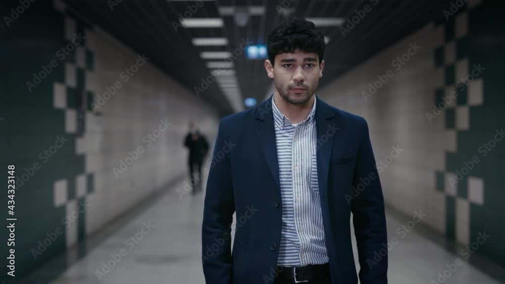 Confident man in business outfit walking in subway station Confident man in business outfit walking in subway station