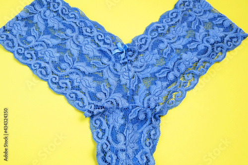 blue lace panties on yellow background. Fashionable lingerie concept photo