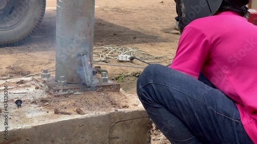Amateur blacksmiths work with welding machines to weld steel frames and to train their skills of welding,Blue fire flickers, orange sparks are flying.