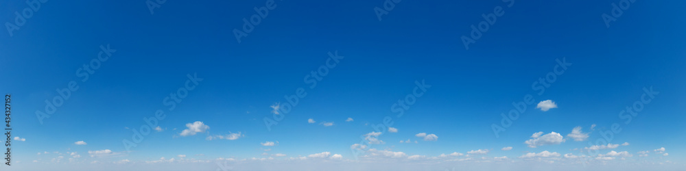 Panoramic fluffy cloud in the blue sky. Sky with cloud on a sunny day. Panoramic fluffy cloud in the blue sky. Sky with cloud on a sunny day.