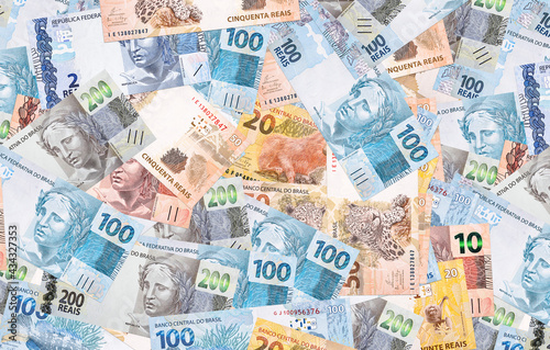 Brazilian reais, different money notes, 100, 50, 20 and 10 reais. Texture background, Brazilian economy concept photo