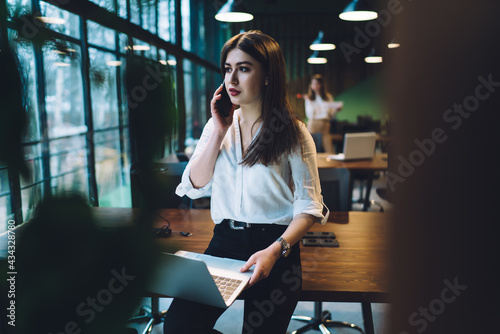 Young businesswoman having conversation on smartphone