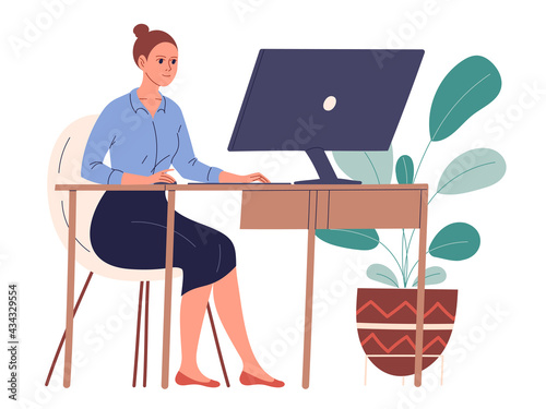 Woman sits at her desk in her workplace and works