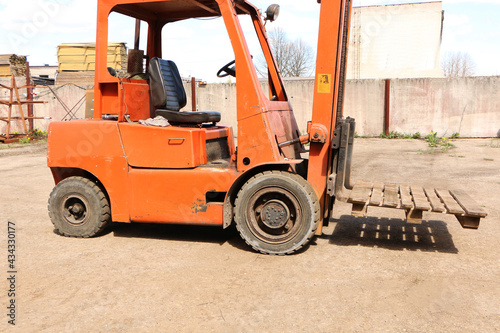 Car - forklift, stacker truck, warehouse forklift. Old car under repair in the garage.