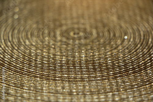 Abstract background of shiny rings with shades of gold with iridescent glitter.